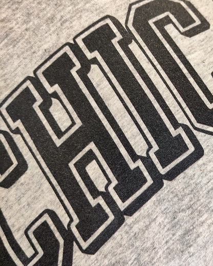 Detail of Chicano-print in bold college style letters, Chicago-parody, eco-friendly organic t-shirt, fair wear